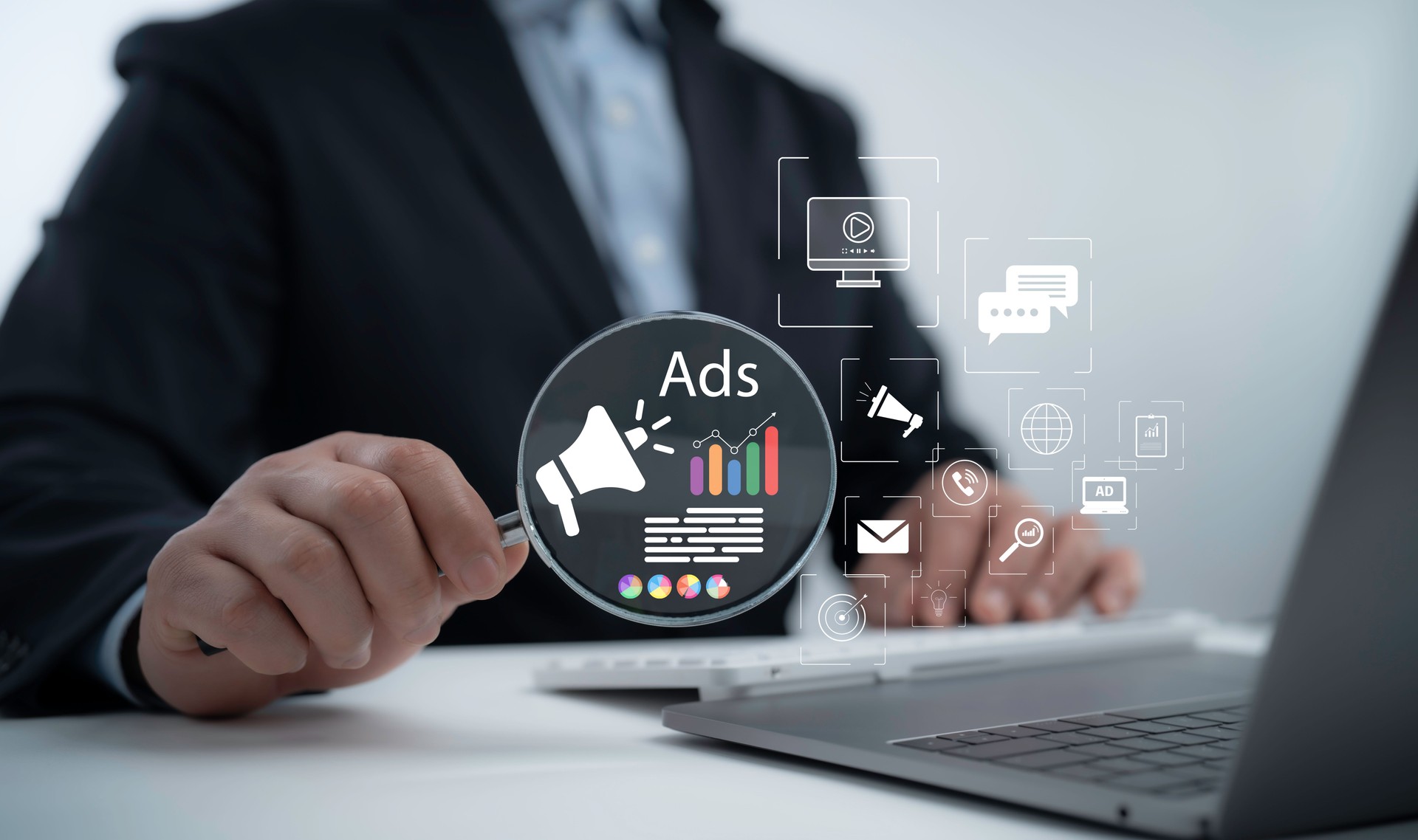 Businessman analyzing online advertising strategy with digital marketing icons and data analytics on a laptop, representing modern business promotion and brand visibility